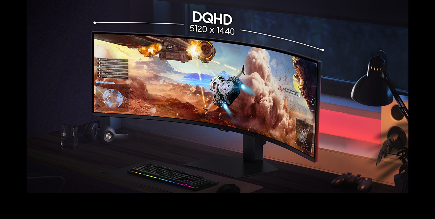 A gaming setup with DQHD 5120 x 1440 curved monitor. Screen shows wide view of small spacecraft shooting towards mothership.