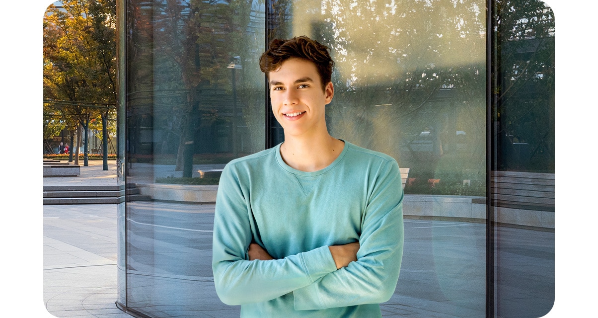 High quality portrait shot of a young man looking into camera lenses, while Reflective windows are shown very clearly.