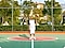 1. A man standing in a basketball court. It is a close crop shot, showing the man and the center of the court.