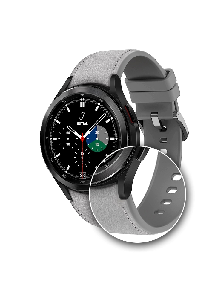 The Galaxy Watch4 is shown with Black color watchface and a Silver Hybrid Leather Band. The band is tied around, forming a circle as one would wear it on their wrist. There is a close-up that zooms into the watch's hinge that connects the watch with the Hybrid Leather band to show the sturdy and firm connection of the band to the watch's body.