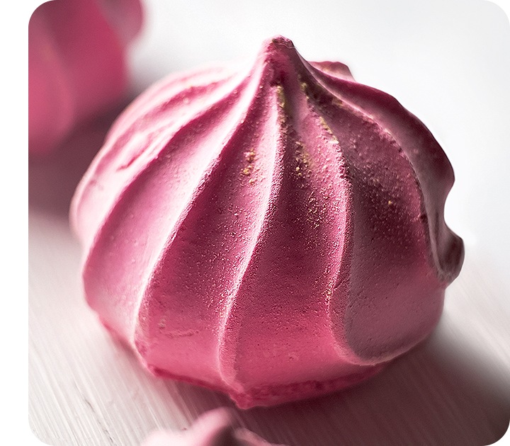 A detailed close-up of a pink meringue taken with the Macro Camera shows its texture clearly.