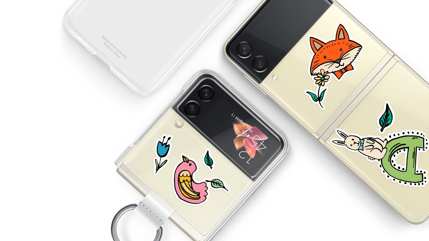 Two Galaxy Z Flip3 5G phones, one folded and one unfolded, both seen from the rear with Clear Cover with Ring installed. They are decorated with graphic stickers. Another Clear Cover with Ring is seen without a phone, showing the transparency of the case.
