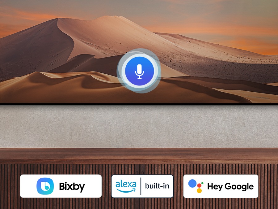 A microphone icon overlays an image, demonstrating voice assistant feature. The Bixby, Alexa built-in and the Hey Google logos are on display on the bottom.