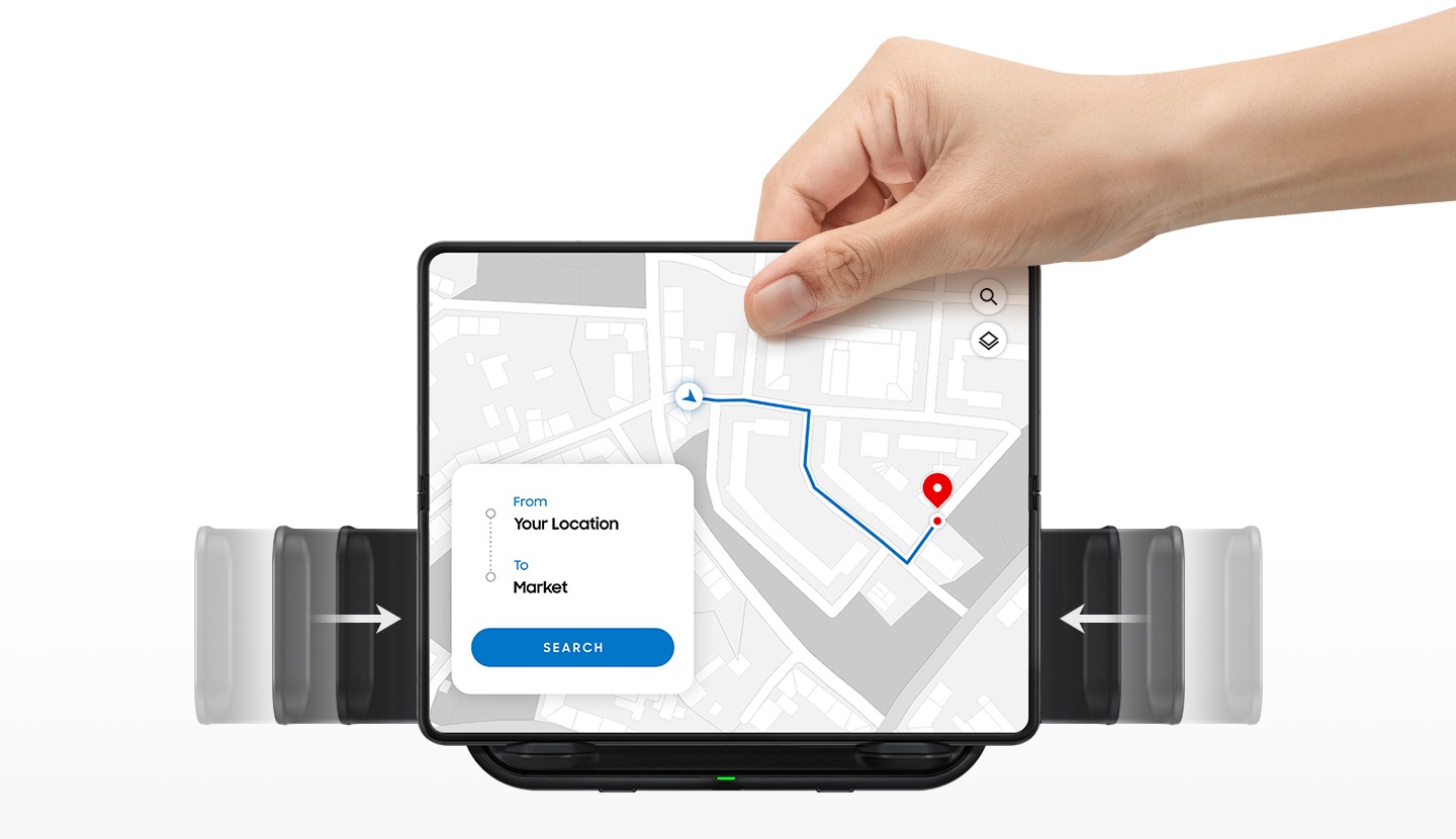 A hand holds the top of a Galaxy Fold. Two arrows on the clamp indicate how the clamp closes to grasp the device. A navigation app is on the phone screen.