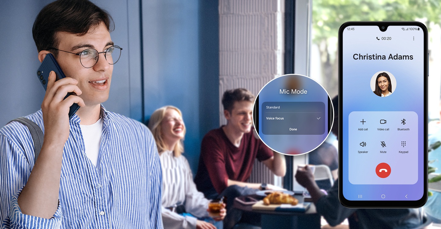 A man is talking on the phone with a loud group of friends laughing and talking behind him. To the right a Galaxy M15 5G device shows that he is talking to Christina Adams, and a pop-up next to the device shows that he is using Voice Focus to speak clearly through the chatter.