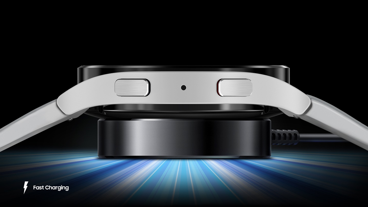 A side view of the Galaxy Watch5 charging with blue lights emitting from the charger to depict speed.