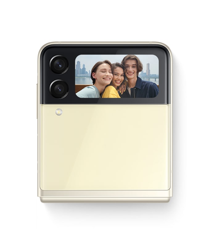 Folded Galaxy Z Flip3 5G seen from the Front Cover with a group selfie on the Cover Screen, being captured with Quick Shot.