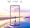 Galaxy A52 seen from the front. A scene of a man standing on a beach at sunset with pink and blue colors in the sky expands outside of the boundaries of the display. Text says Brightness 800 nits, Eye Comfort Shield, with the SGS logo and Real Smooth.