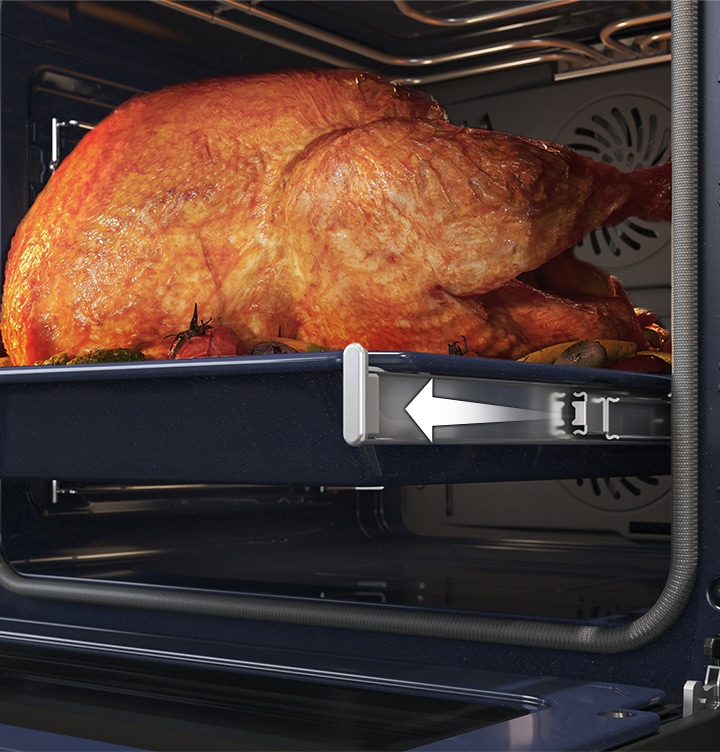 Shows a large roast turkey sliding out of the oven on the Telescopic Rail.