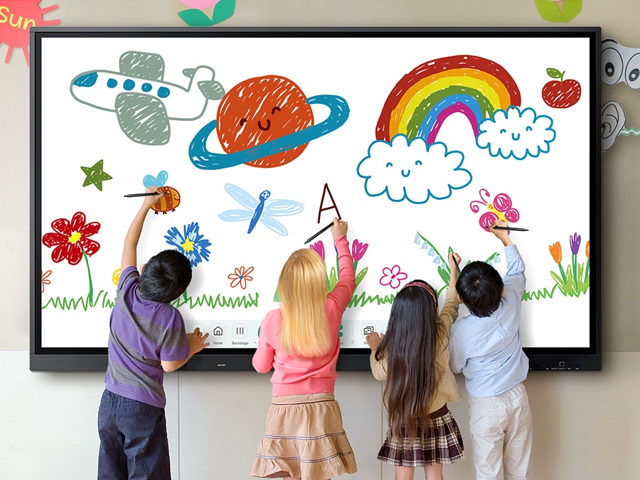 Four children are drawing with pens on the WAD at the same time.