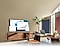 In un ufficio domestico in soggiorno, lo schermo della TV QLED mostra la funzione PC su TV che consente alla TV di casa di connettersi al PC dell'ufficio.