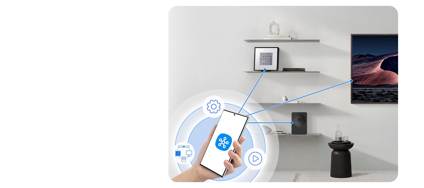 Hand holding a phone with the SmartThings app, wirelessly controlling compatible devices, including Music Studio 7 speaker.