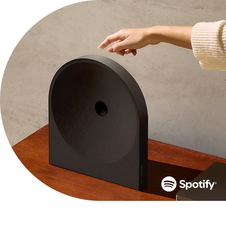 Hand tapping on Music Studio 5 Speaker. Spotify logo.
