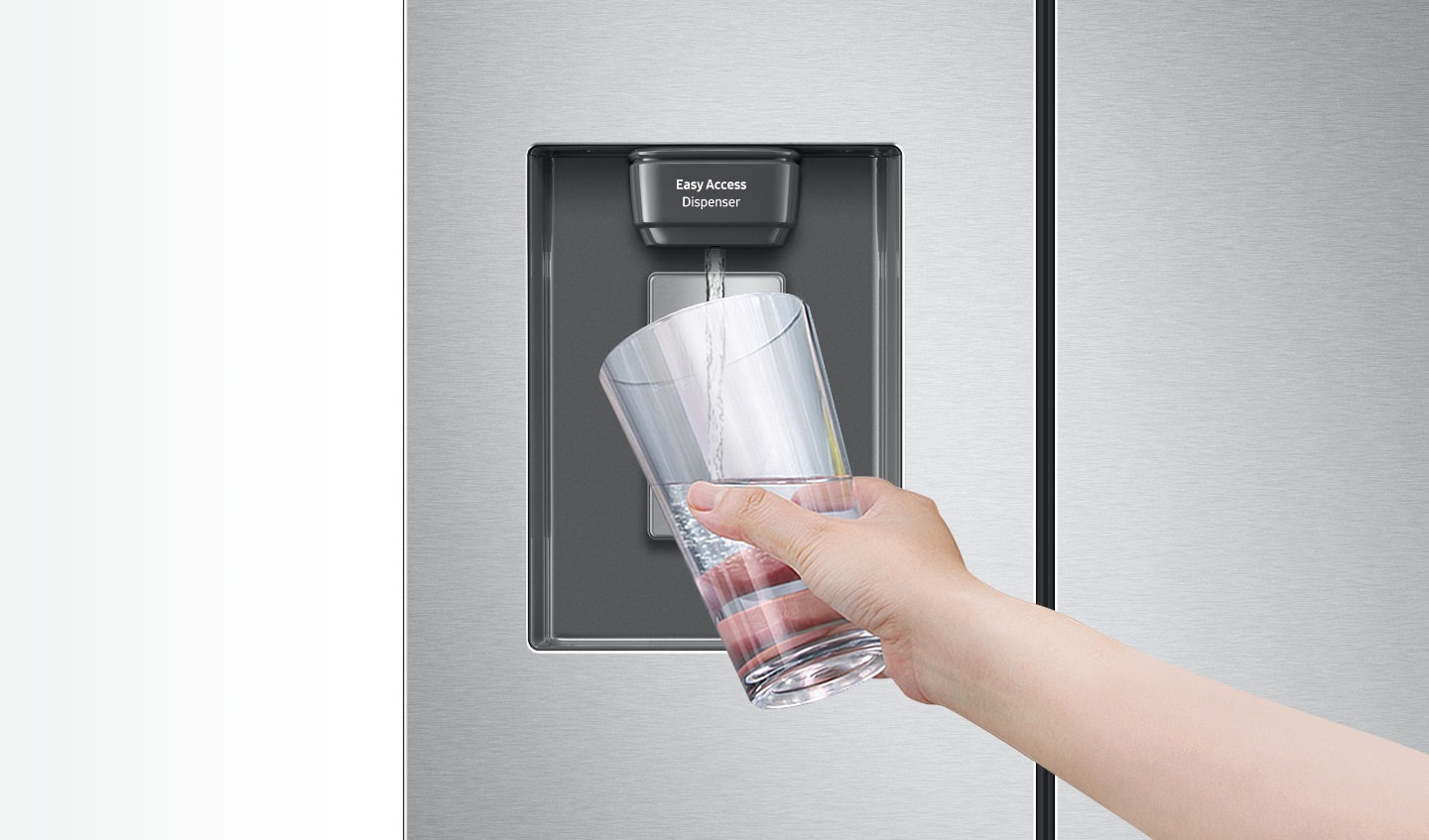 A user fills a cup with water from a easy access dispenser.