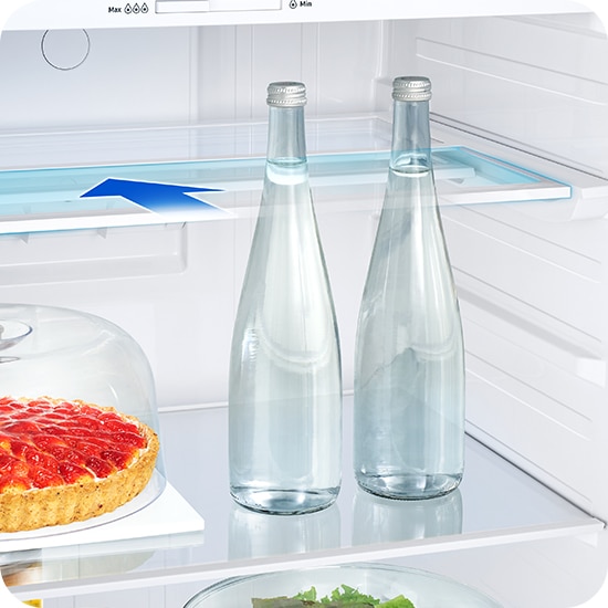There are arrows to indicate that the shelf slides half its width inside the refrigerator. This way you can not only store cakes, but also high bottles on the shelf.
