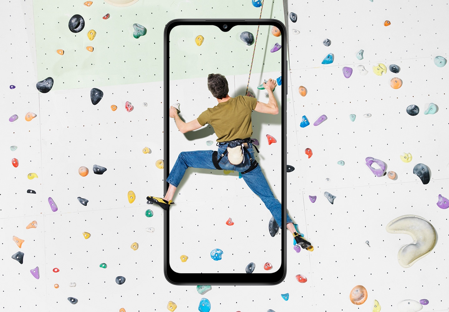 A guy climbing in motion captured in Galaxy A12 display, utilizing 6.5 inch Infinity-V display feature.