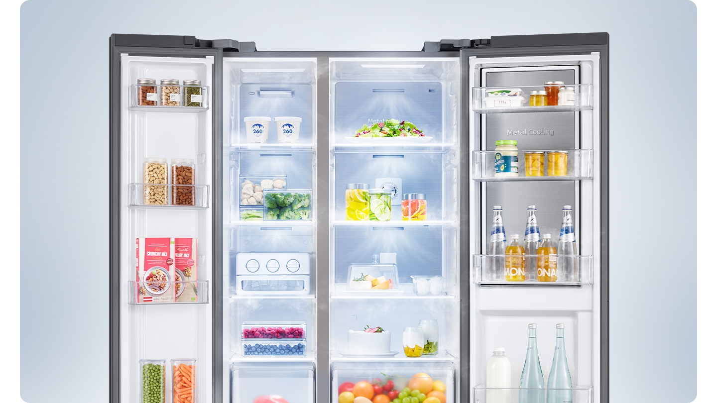 A 2-door fridge is open fully with food inside, and fresh air is coming out from the top of each compartment.