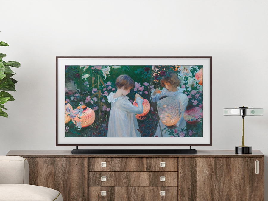 Samsung The Frame's height can be adjusted to your preference using the Height Adjustable Stand. A Soundbar is placed below The Frame TV at a perfect space