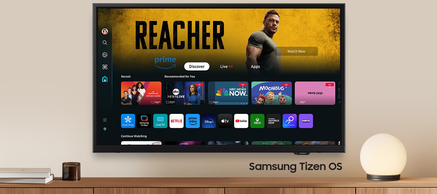 A wall-mounted TV shows popular apps and curated content on the home menu. "Samsung Tizen OS"