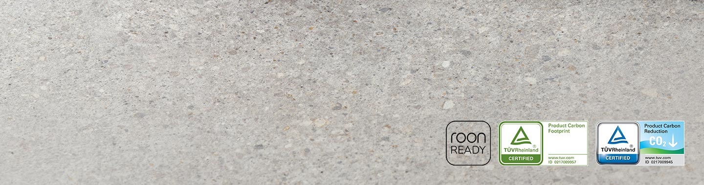 Close-up of QS700F soundbar's side panel. Roon Ready logo. TUV Rheinland Certified Product Carbon Footprint www.tuv.com ID 0217009957 logo. TUV Rheinland® Certified Product Carbon Reduction CO2↓ www.tuv.com ID 0217009945 logo.