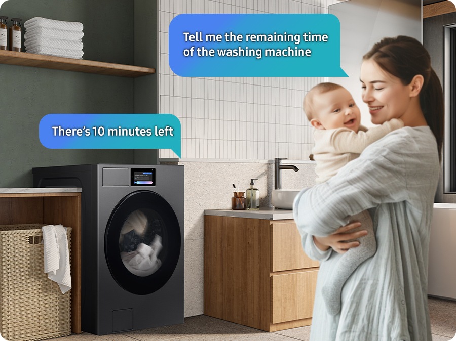 A woman holding a child in a laundry room asks Bixby the remaining time in the cycle, "Tell me the remaining time of the washing machine.". Bixby replies from the washer, "There's 10 minutes left.".
