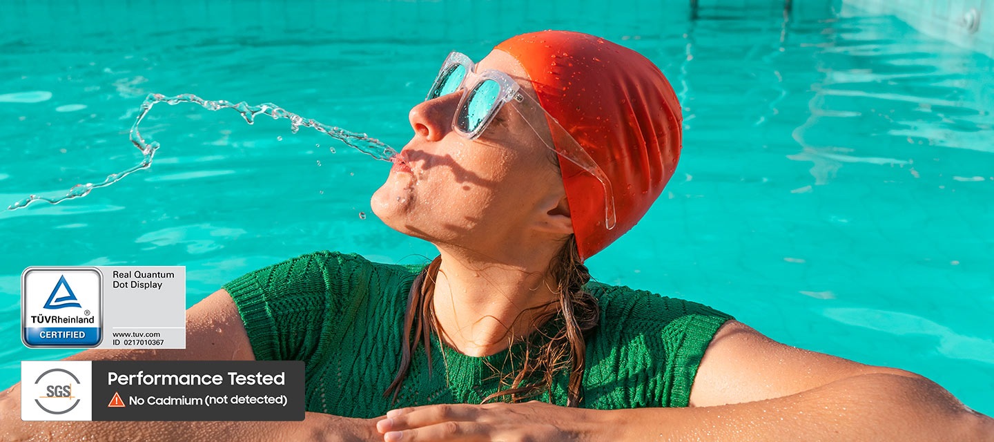Cảnh một người phụ nữ đang nhổ nước trong bể bơi trông mờ nhạt và thiếu sức sống. Sau đó, một hiệu ứng chuyển cảnh tuyến tính cho thấy hình ảnh hiển thị trên màn hình Real QLED với tất cả các màu sắc tươi sáng và sống động như thật. Chứng nhận TUV Rheinland, Màn hình chấm lượng tử thực sự, www.tuv.com, logo ID 0217010367. Logo SGS đã kiểm tra hiệu năng, không phát hiện Cadmium.