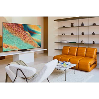 A Neo QLED TV is set on a stand in a modern living room. The TV displays an otherworldly grassy landscape in green and orange colors.