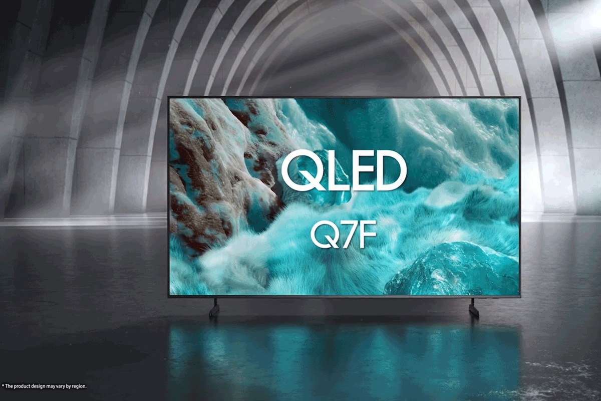 Samsung QLED Q7F TV in a black and white indoor space displays a colorful scene of an otherworldly landscape.