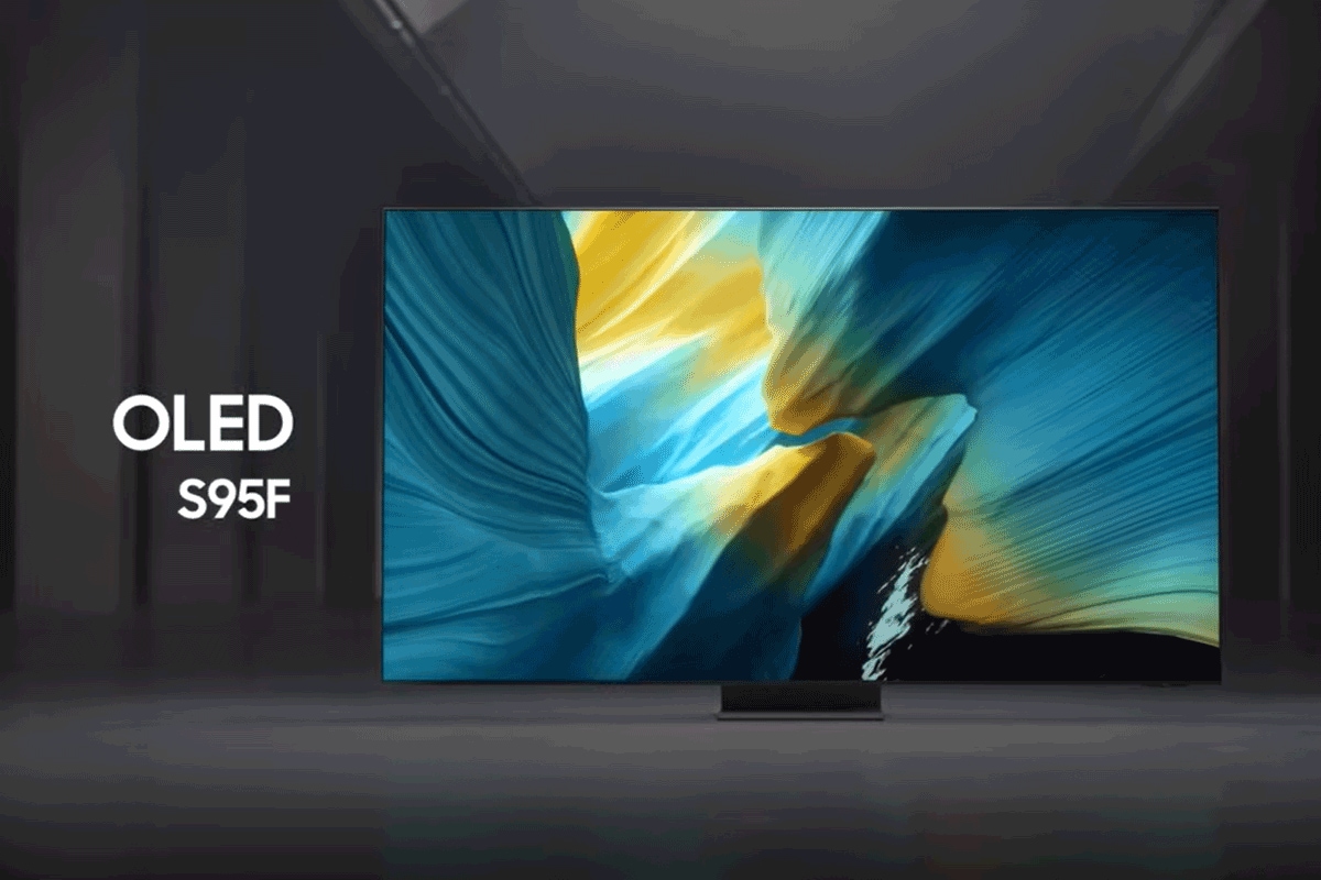Samsung OLED S95F TV in a black and white indoor space displays a colorful scene of an otherworldly landscape.