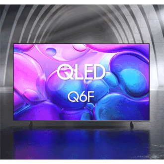 Samsung QLED Q6F TV in a black and white indoor space displays an abstract scene of purple bubbles. 