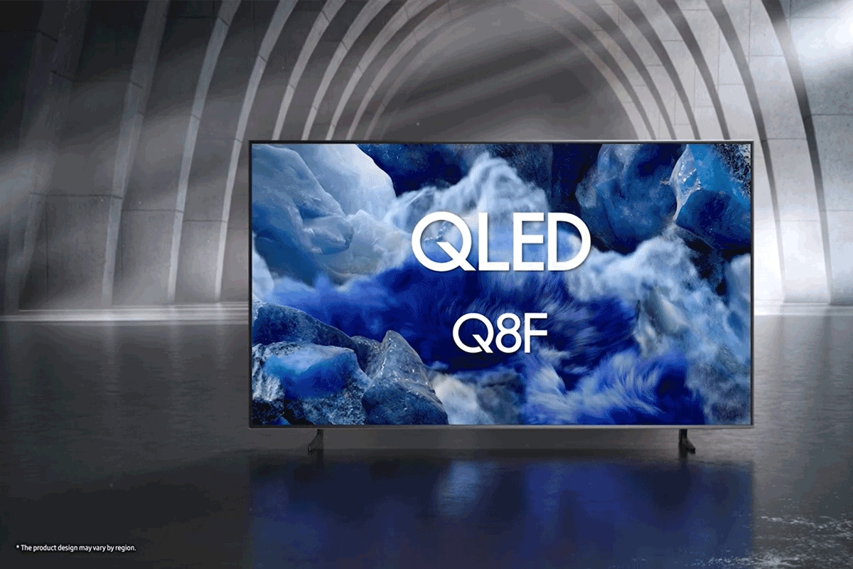 Samsung QLED Q8F TV in a black and white indoor space displays a colorful scene of an otherworldly landscape.