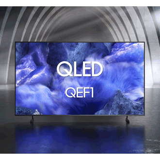 Samsung QLED QEF1 TV in a black and white indoor space displays a colorful scene of an otherworldly landscape.