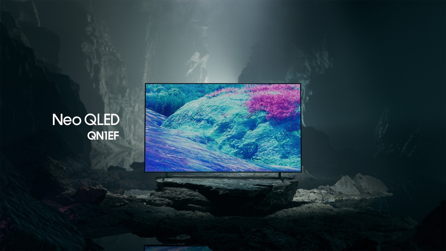 Samsung Neo QLED QN1EF TV in a black and white underground space displays a colorful scene of an otherworldly landscape.