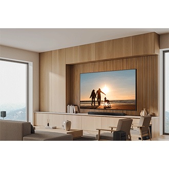 Wall-mounted QN87D and Soundbar in a wood-toned living room.