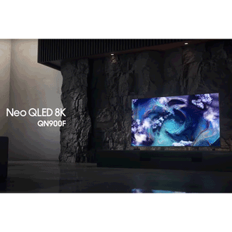 Samsung Neo QLED 8K QN900F TV on TV cabinet in a black and white space displays colorful scene of an otherworldly landscape.