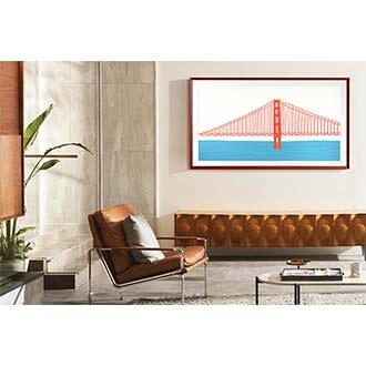 The Frame TV with Customizable Frame Bezel which is brick red beveled style is wall-mounted in a living room.