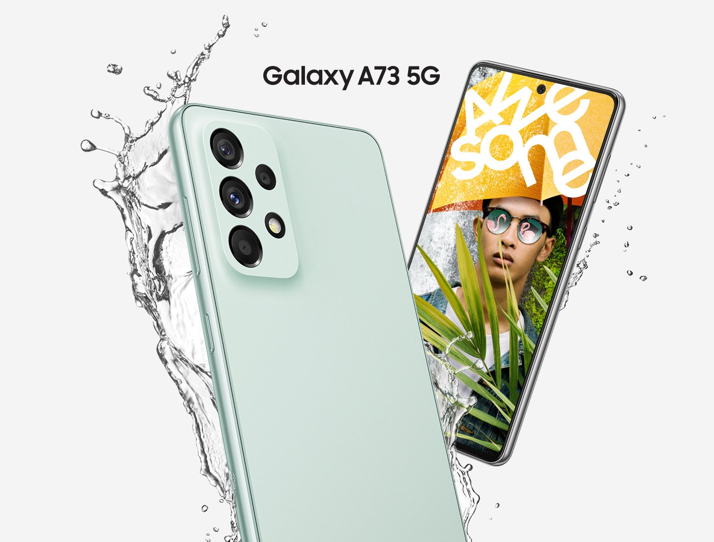 Two Galaxy A73 5G devices, in Awesome Mint, are shown with one device showing the back and the other showing the front.  Water is being splashed to display the water-resistance while the front-siding device shows a man wearing a yellow umbrella that has Awesome written in white text.