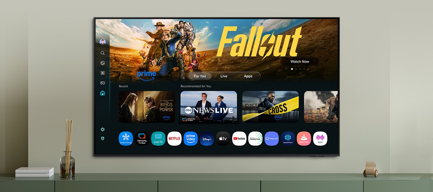 One UI Tizen’s home screen, with the various apps and services available, is displayed on a TV in a living room.