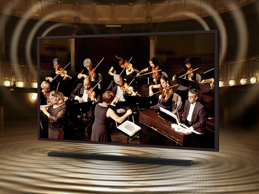The Frame is showing an orchestra on its screen. The Soundbar is below The Frame with sound ripples coming out of it to show that the sound of the speakers on The Frame and Soundbar are perfectly synced.