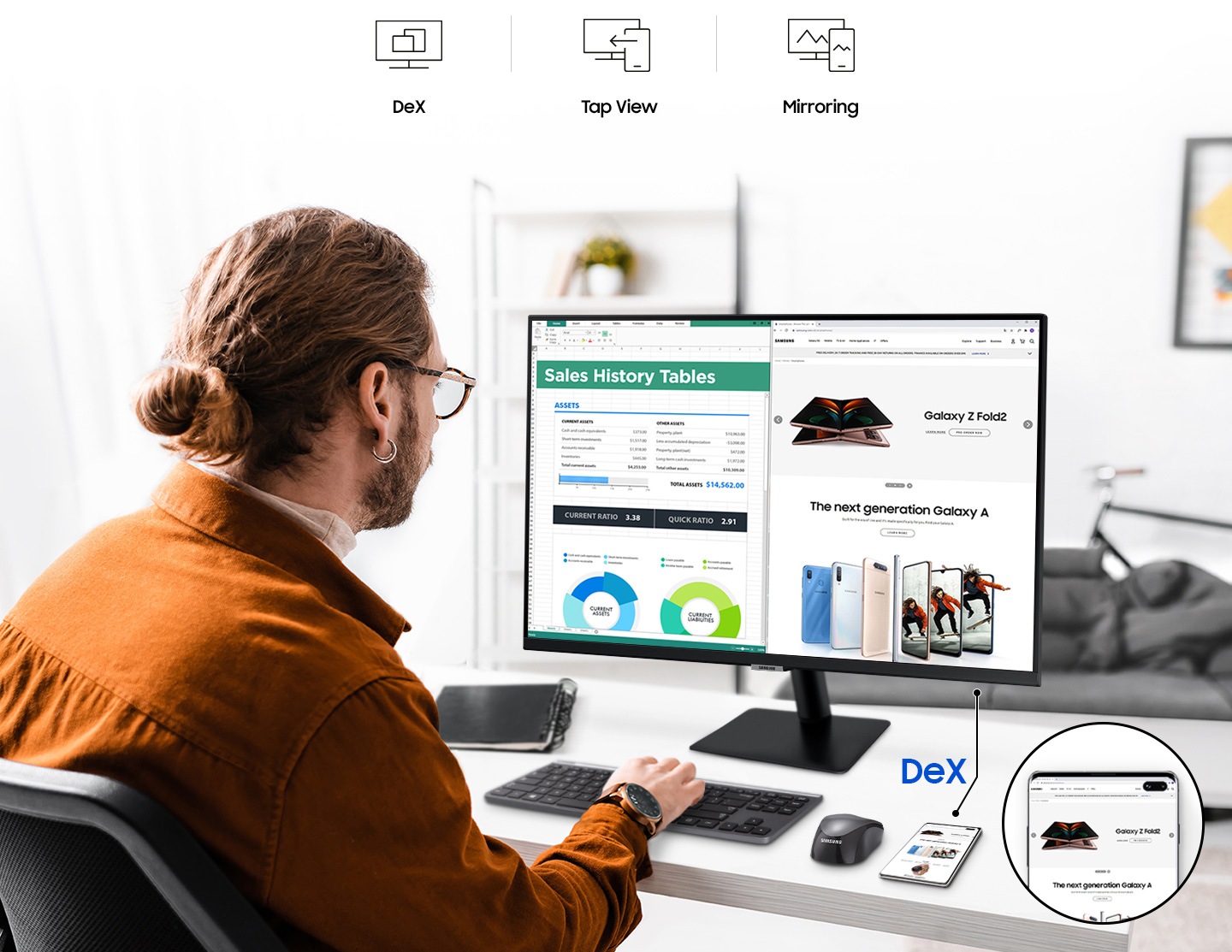 A man working on the 32 inch Samsung M7 Monitor, his phone mirrored to the M7 Smart Monitor via the Samsung DeX application.