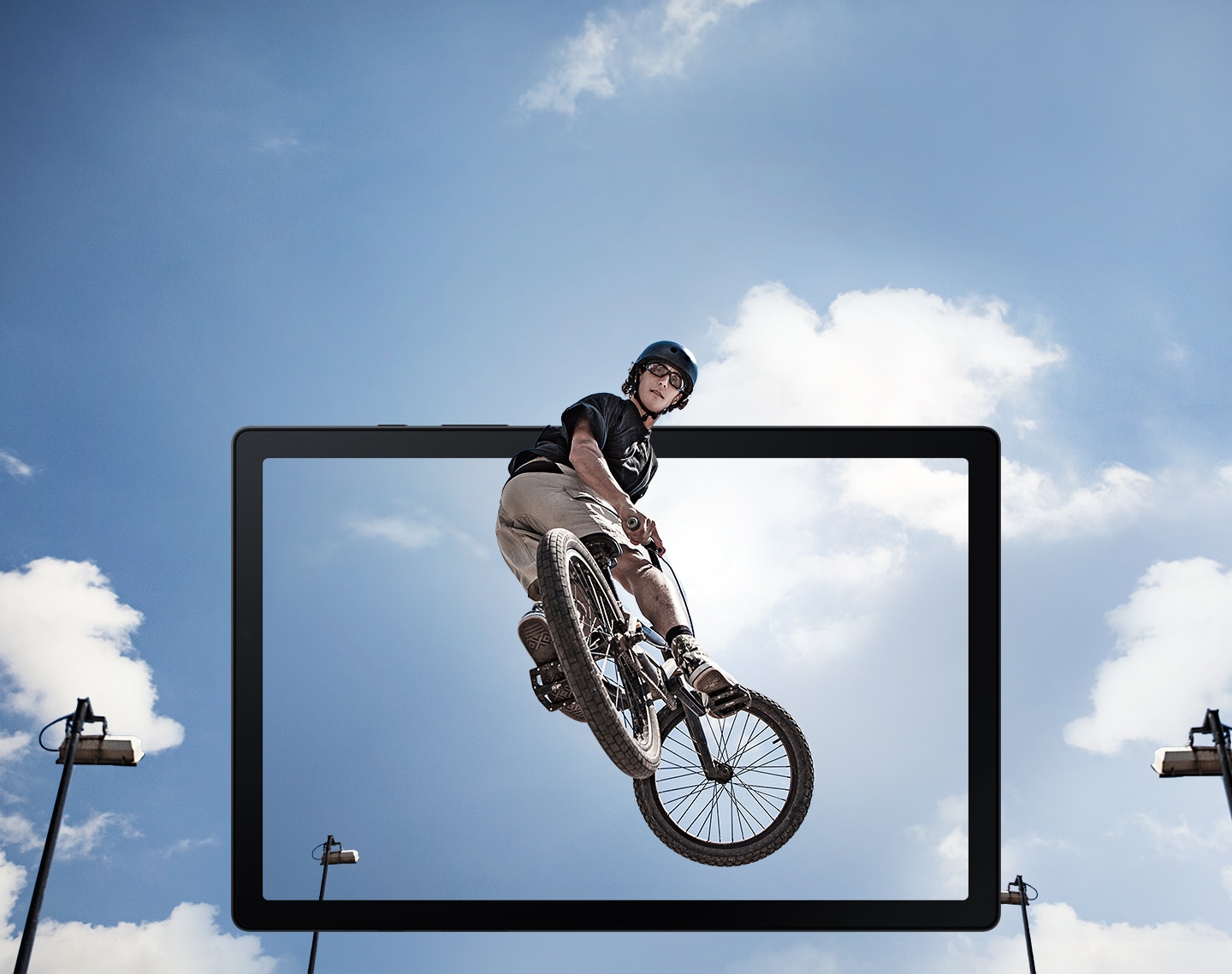 Samsung Tab A8 - A man doing a jump on a BMX bicycle in the air is shown popping out of a tablet screen.