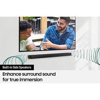 A TV shows a scene of two men talking, with the built-in side speakers in the Soundbar enhancing surround sound.