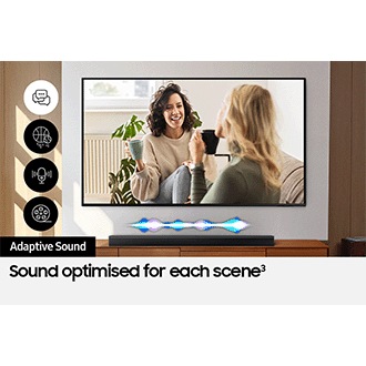 A TV shows a scene of two women talking. Adaptive Sound optimises the Soundbar's audio, shown by a fluctuating sound wave.
