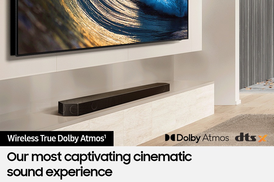 Samsung Soundbar connected wirelessly to TV. Dolby Atmos logo and DTS:X logo.