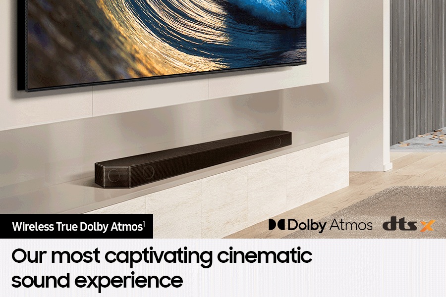 Samsung Soundbar connected wirelessly to TV. Dolby Atmos logo and DTS:X logo.