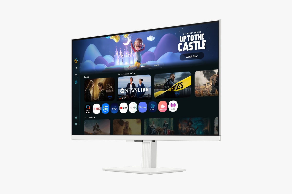  Front-left perspective of 27 inch Samsung Smart Monitor M5. Screen showing Smart TV Apps page with various content and apps lined up.