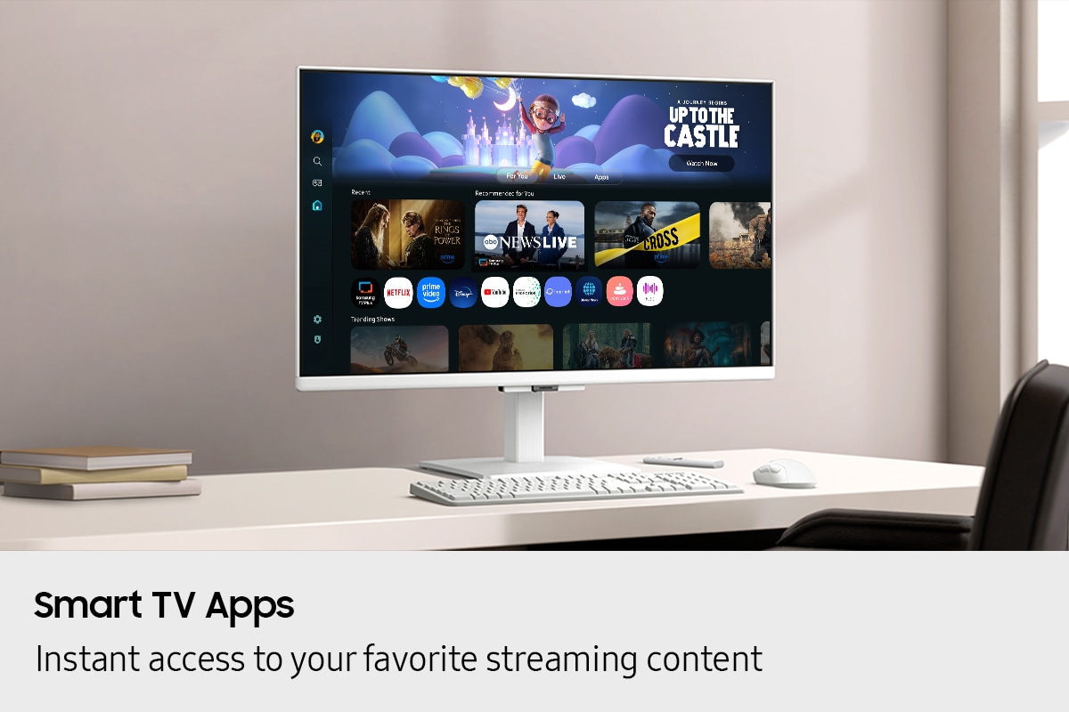 Smart TV Apps. Instant access to your favourite streaming content. Monitor on desk displays Smart TV Apps page with various content and apps lined up.