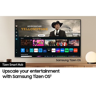 A wall-mounted TV shows popular apps and curated content on the "Samsung Tizen Smart Hub" home menu.
