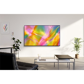Samsung M60H TV mounted on the wall in a bright living room displaying a vibrant abstract  scene.