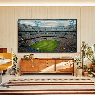 A U8500F is installed on the wall of a living room. It depicts a scene of a crowded stadium in vivid colors.